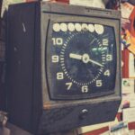 black and brown analog desk clock