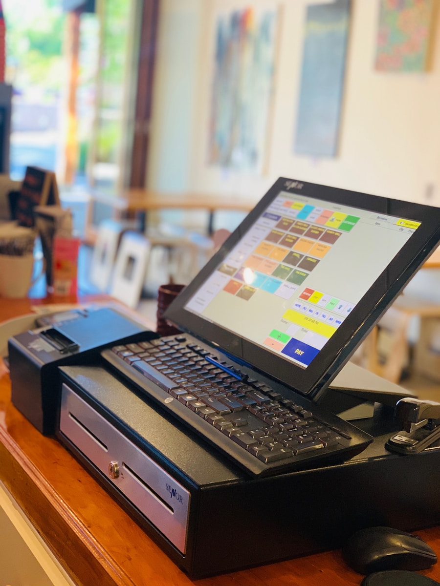 black laptop computer on brown wooden table