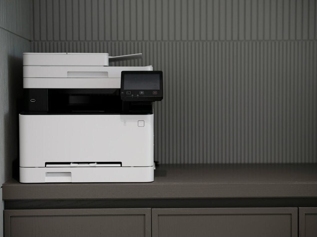 a white and black printer sitting on top of a counter